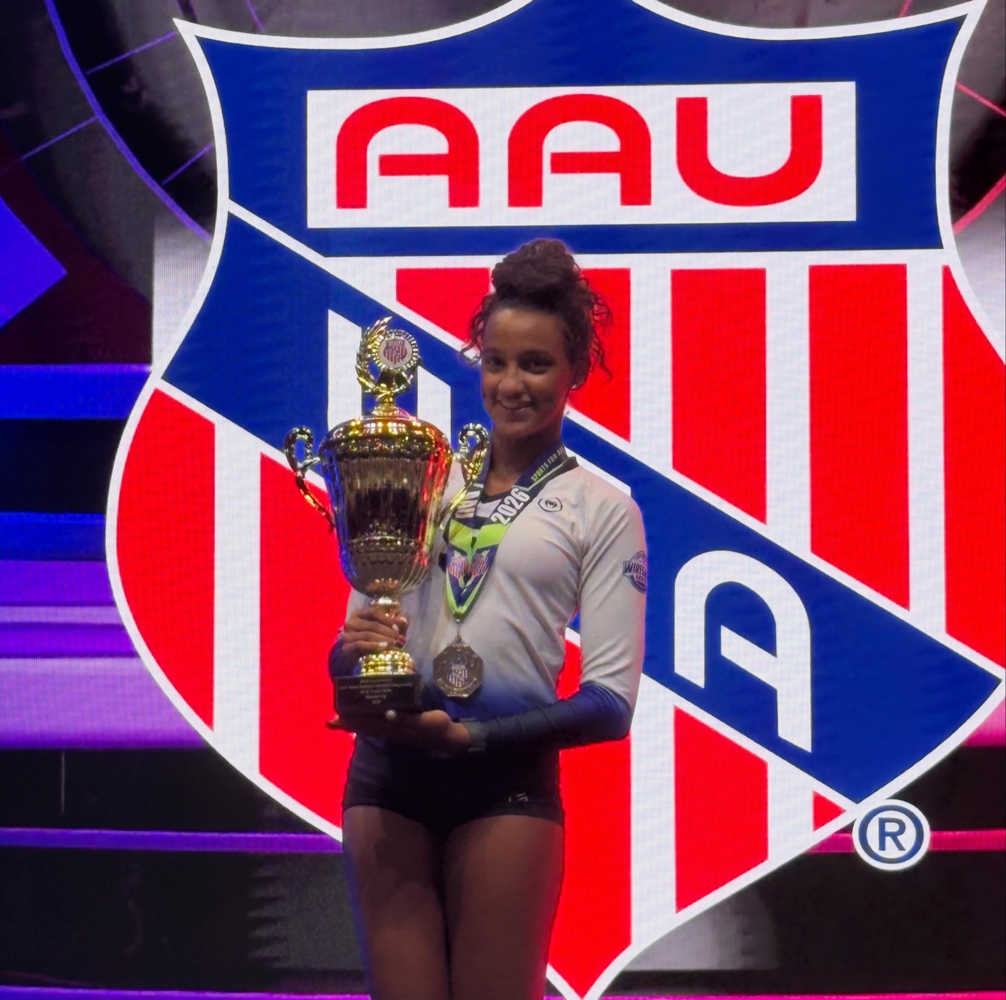 Lia Black with volleyball achievement trophy